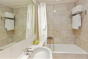 a bathroom with a sink and a tub and a shower at Congo Palace in Athens