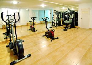 a gym with several treadmills and exercise bikes at Chiang Mai Lodge in Chiang Mai