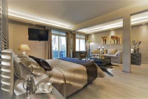 a bedroom with a large bed and a living room at Congo Palace in Athens