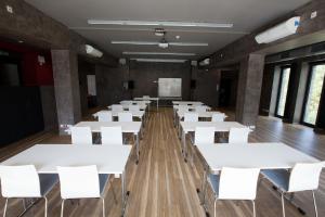 a classroom with white tables and white chairs at Dom Studenta AŁ in Łomża