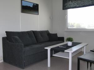a living room with a couch and a table at Vreta Kloster Golfklubb in Ljungsbro