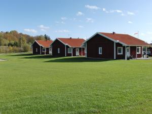 two houses in a field with green grass at Vreta Kloster Golfklubb in Ljungsbro