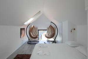 a bedroom with a bed and two mirrors at 7 Gaia Roaster Apartments in Vila Nova de Gaia