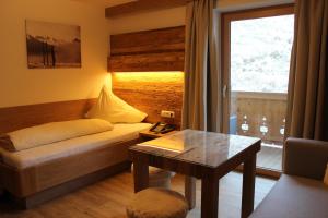 a hotel room with a table and chairs at Pension Michael in Saalbach-Hinterglemm