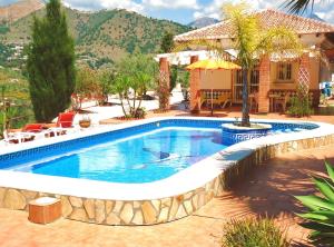 een zwembad voor een huis bij Peperent Villa Al-Andalus in Cómpeta