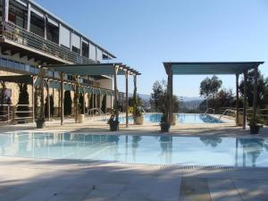a pool at a hotel with a pavilion at Coimbra Camping & Bungalows in Coimbra