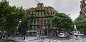 a tall yellow building on a city street with a street at Rocafort SDB in Barcelona