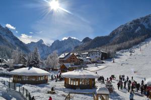a group of people on a ski slope in the snow at Skier's cave in Kranjska Gora