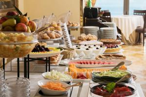 a buffet filled with different types of food on a table at Grand Hotel Due Golfi in SantʼAgata sui Due Golfi