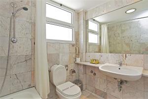a bathroom with a toilet and a sink and a shower at Congo Palace in Athens