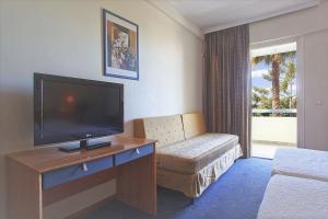 a hotel room with a television and a living room at Congo Palace in Athens