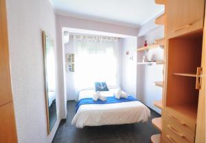マラガにあるHolidays2Malaga Hermosilla 3 dormitorios & parking Wifi Fibra 600 MGの小さなベッドルーム(ベッド1台、窓付)