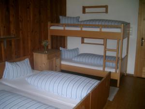 two bunk beds in a room with two beds at Pension Steinerhof in Oberau +33 photos