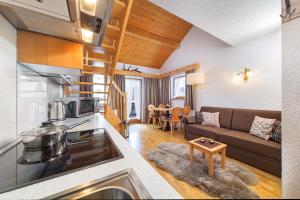 a kitchen and living room with a couch and a table at Ferienhaus Knor in Umhausen +154 photos