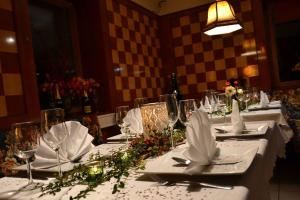 a table with white table cloths and flowers on it at Gasthaus Tisis in Feldkirch