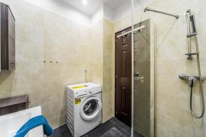 a bathroom with a washing machine and a shower at KIRÁLY 38 2BEDROOM AIRCON ENTIRE APARTMENT in Budapest
