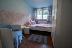 a small bedroom with a bed and a window at Chata pod Skocznią in Szczyrk