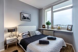 a bedroom with a bed with two pillows on it at ClickTheFlat Tamka Street Apart Rooms in Warsaw