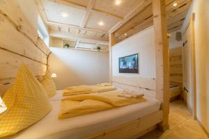 a bedroom with a bed in a wooden house at Apartments Landhaus Sonnheim in Lofer