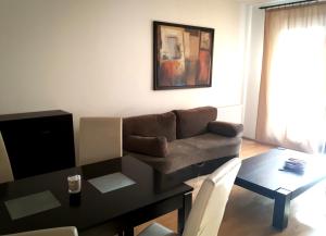 a living room with a couch and a table at Gozsdu Suite Apartment in Budapest