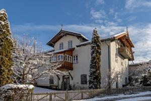 a house with a fence in the snow at Haus Haggenmüller in Hopfgarten im Brixental