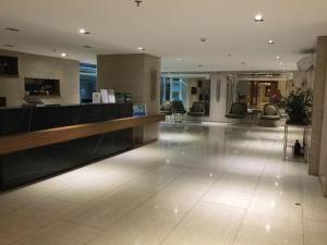a lobby with a reception desk in a building at Breezy Tagaytay Condo in Tagaytay