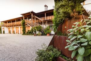 an exterior view of a building with plants at St. Ulrichhof in Lana