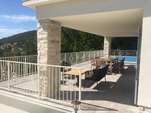 a balcony of a house with a table and chairs at Villa Carmen in Opatija