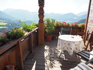 a table and chairs on a balcony with a view at Ferienwohnung Hübner in Brandenberg