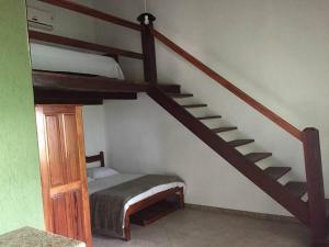 a bedroom with a bunk bed and a staircase at Pousada Recanto Verde e Mar in Araruama