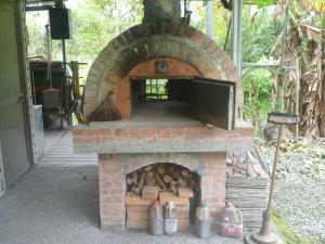 a brick oven with a pile of logs in it at Shan Bian 52 Homestay in Fengshan