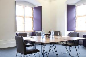 a conference room with a wooden table and chairs at Schloss Weitenburg in Starzach