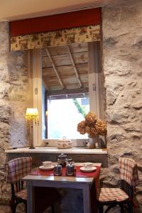 a dining room with a table and a window at Villa Bon Repos in Argelès-Gazost