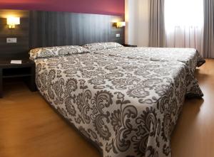 Postel nebo postele na pokoji v ubytování Hotel Abades Via Norte