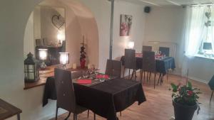 un comedor con mesa y sillas en una habitación en Chambres d'hôtes au Pays des Etangs, en Bourgaltroff