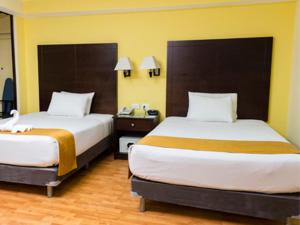 Postel nebo postele na pokoji v ubytování Hotel Madan Cárdenas