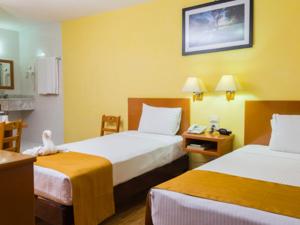 Postel nebo postele na pokoji v ubytování Hotel Madan Cárdenas