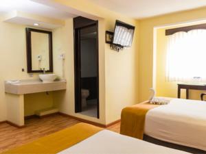 Postel nebo postele na pokoji v ubytování Hotel Madan Cárdenas
