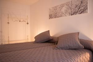 a bedroom with a bed with two pillows on it at Cal Fasi in Torá de Rulbregos