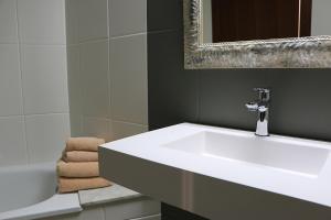 a bathroom with a white sink and a mirror at Cal Fasi in Torá de Rulbregos