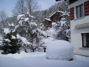 a pile of snow in front of a house at Chalet "Le 19 x 27" in Morzine