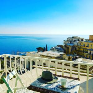 a table and chairs on a balcony with a view of the ocean at Hotel Villa Delle Palme in Positano in Positano