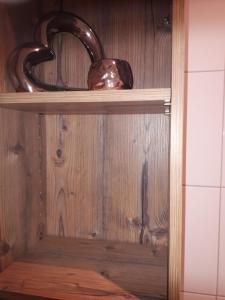 a wooden shelf with a bowl and a vase on it at Apart Sissy in See