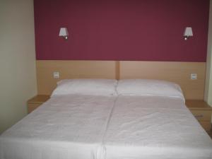 Postel nebo postele na pokoji v ubytování Hostal Ducal