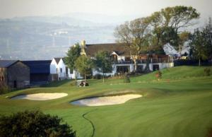 a golf course with a hole in the middle of a green at The Gower Golf Club B&B in Gowerton