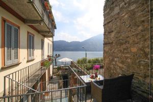 a balcony of a building with a view of the water at Little Luxury Suite in Tremezzo