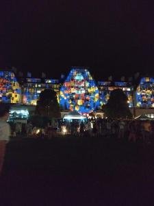 a group of buildings lit up at night at Petrópolis no Palácio Quitandinha: conforto e Paz in Petrópolis