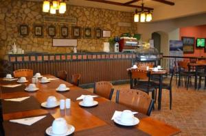 a dining room with tables and chairs in a restaurant at Three-Bedroom Garden Chalet at Marina Wadi Degla For Families in Ain Sokhna