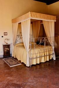 a bedroom with a canopy bed in a room at Villa Aurora di Ferracciano in Borgo San Lorenzo