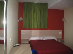 Postel nebo postele na pokoji v ubytování Hostal Ducal